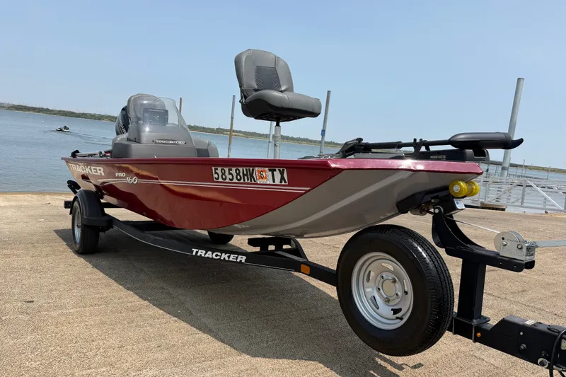 The Image of 2020 Tracker Pro 160 boat on trailer by a lake, ready for launch. - 0