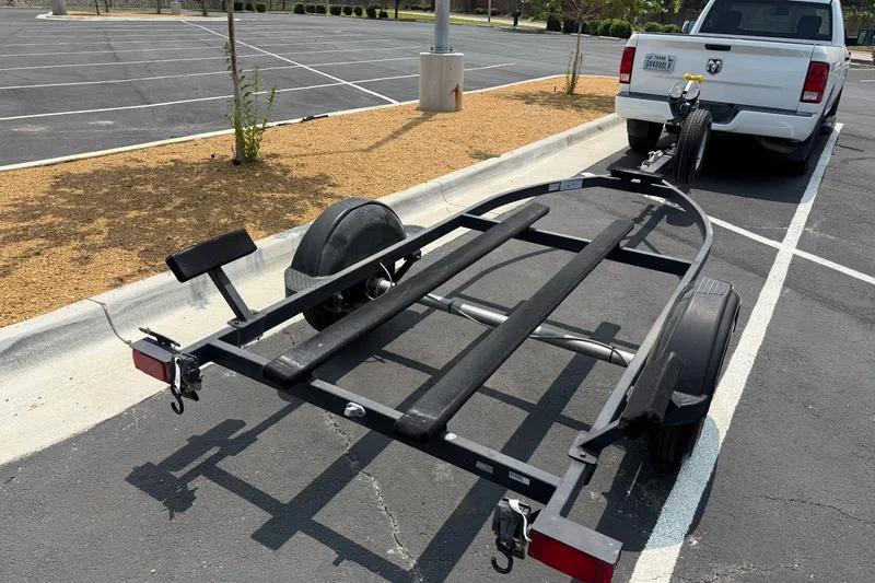Slide: The Image of Trailer for 2020 Tracker Pro 160 boat hitched to a white truck in parking lot. - 31