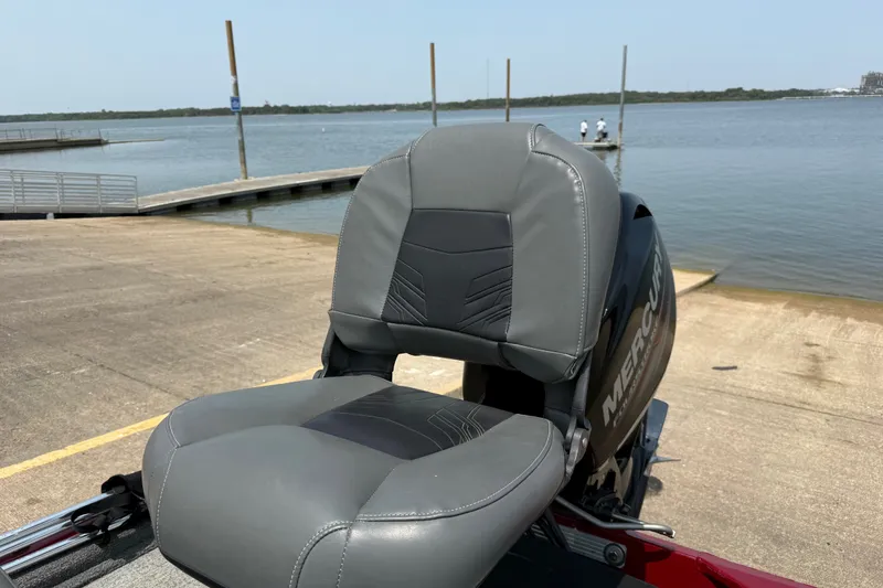 Slide: The Image of Gray seat on 2020 Tracker Pro 160 boat by a lake dock. - 25