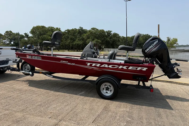 Slide: The Image of 2020 Tracker Pro 160 boat with Mercury engine on trailer, parked outdoors. - 13