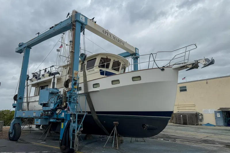 Slide: The Image of 2008 Krogen 48 North Sea yacht on a lift at Apex Marine under cloudy skies. - 71