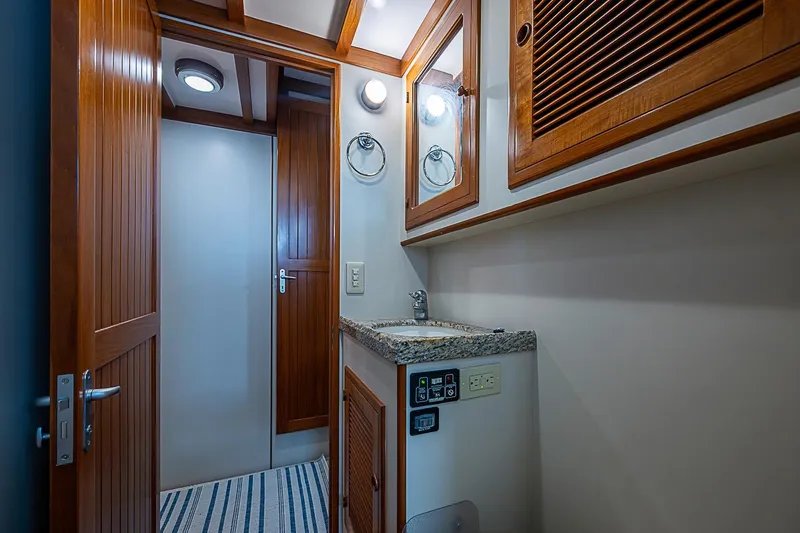 Slide: The Image of 2008 Krogen 48 North Sea yacht bathroom with wooden cabinetry and granite countertop. - 34