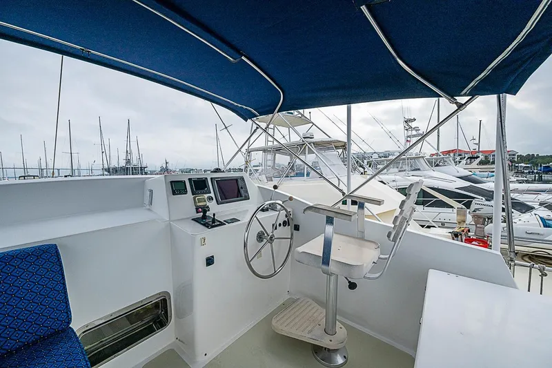 Slide: The Image of Helm station of 2008 Krogen 48 North Sea yacht with marina view. - 56