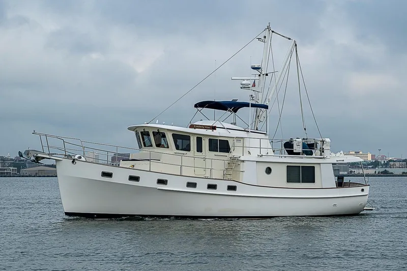 Slide: The Image of 2008 Krogen 48 North Sea yacht on calm waters under cloudy skies. - 4