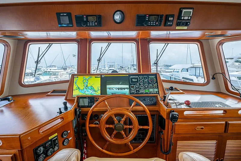 Slide: The Image of Pilothouse of 2008 Krogen 48 North Sea yacht with navigation equipment and wooden steering wheel. - 26