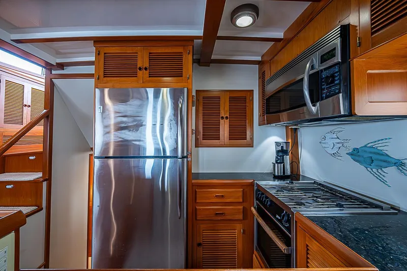 Slide: The Image of 2008 Krogen 48 North Sea yacht kitchen with stainless steel appliances and wooden cabinetry. - 23