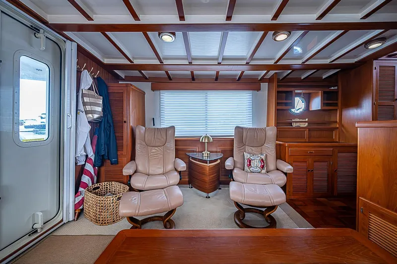 Slide: The Image of Luxurious 2008 Krogen 48 North Sea yacht interior with leather chairs and wooden cabinetry. - 16