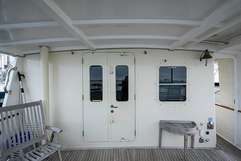 Slide: The Image of 2008 Krogen 48 North Sea yacht deck with seating and door. - 49