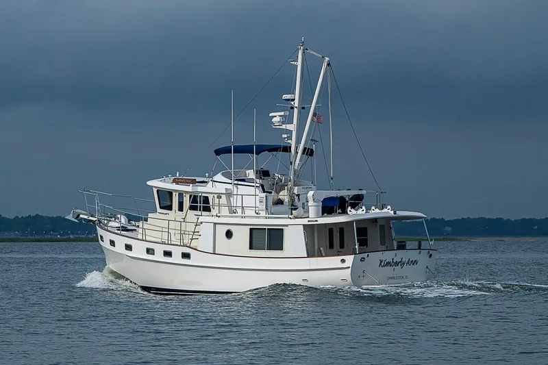 Slide: The Image of 2008 Krogen 48 North Sea yacht cruising on calm waters under a cloudy sky. - 10