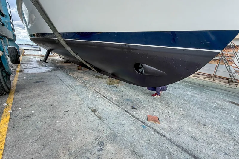 Slide: The Image of 2008 Krogen 48 North Sea yacht on dry dock, showcasing hull and propeller details. - 66