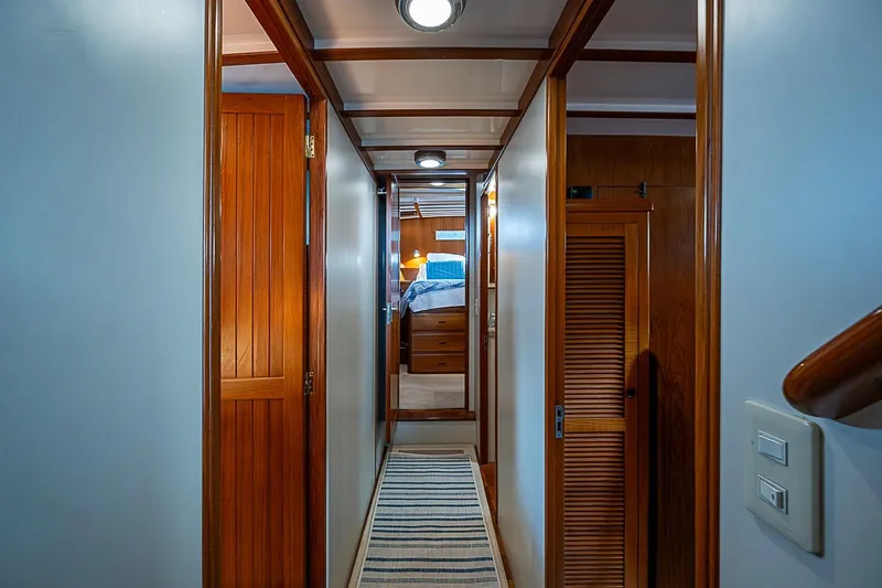 Slide: The Image of Hallway of 2008 Krogen 48 North Sea yacht with wooden doors and cozy lighting. - 35
