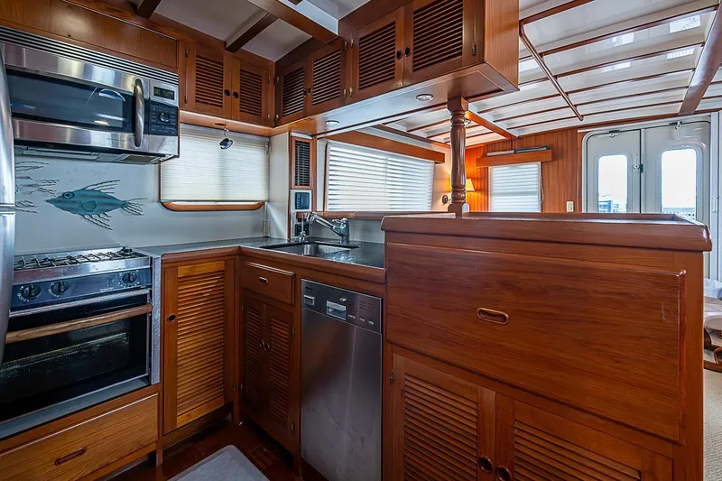 Slide: The Image of 2008 Krogen 48 North Sea yacht kitchen with wood cabinetry and stainless steel appliances. - 21