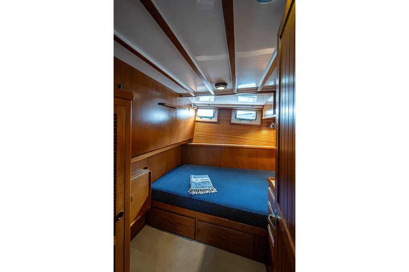 Slide: The Image of Cozy cabin interior of 2008 Krogen 48 North Sea yacht with wooden paneling and blue bedding. - 40