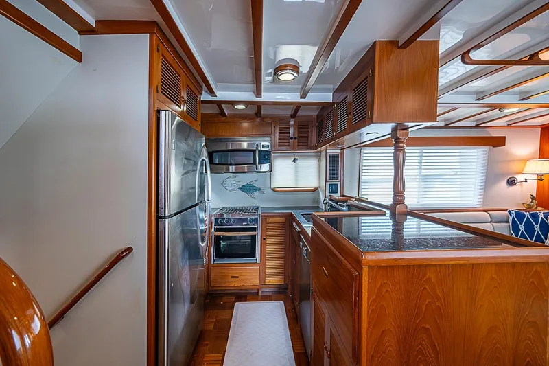 Slide: The Image of Luxurious 2008 Krogen 48 North Sea yacht kitchen with wood cabinetry and stainless steel appliances. - 20