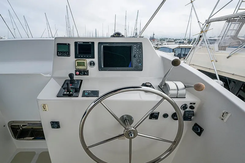 Slide: The Image of Helm of 2008 Krogen 48 North Sea yacht with navigation instruments and steering wheel. - 57