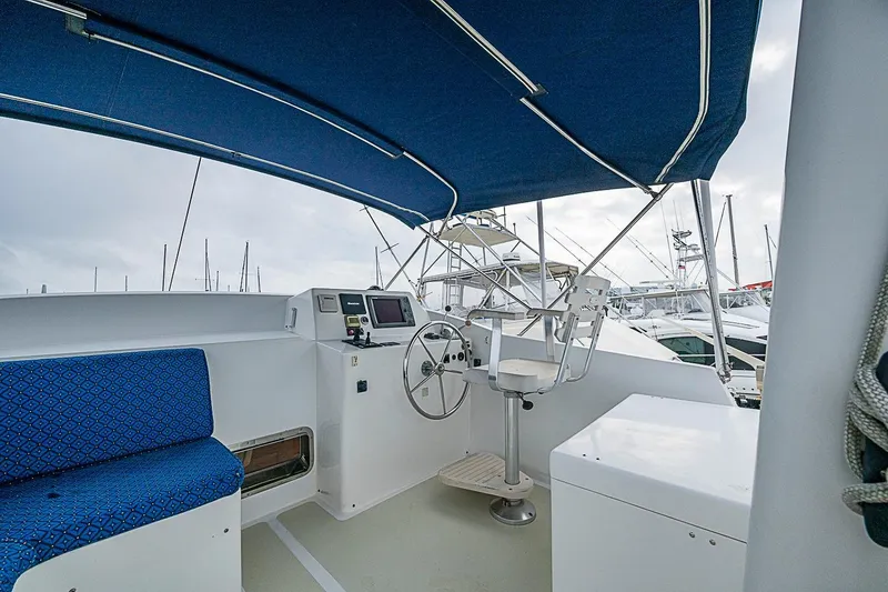 Slide: The Image of Helm station of 2008 Krogen 48 North Sea yacht with blue canopy and seating. - 55
