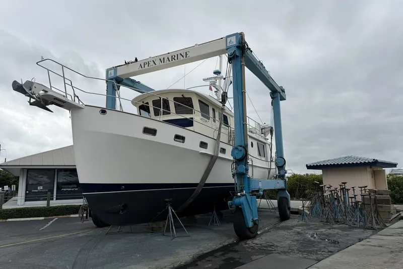 Slide: The Image of 2008 Krogen 48 North Sea yacht on a lift at Apex Marine, overcast sky. - 72