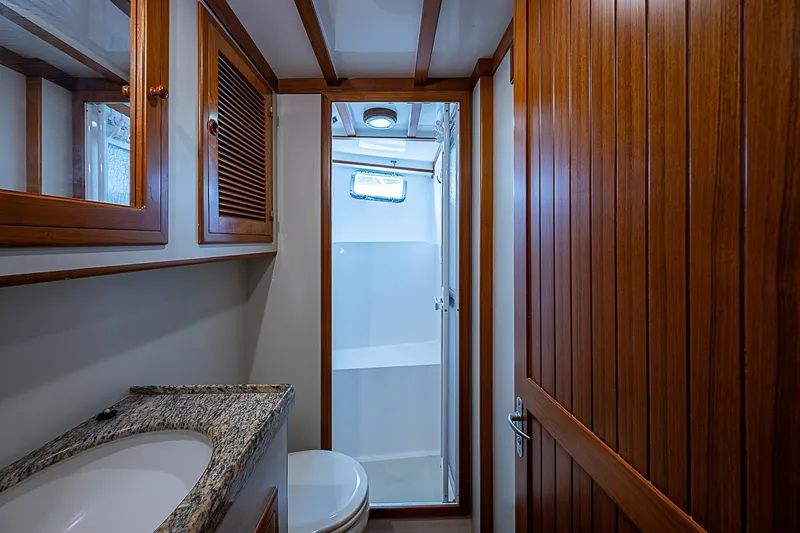 Slide: The Image of Bathroom interior of 2008 Krogen 48 North Sea yacht with wooden cabinetry and granite countertop. - 33