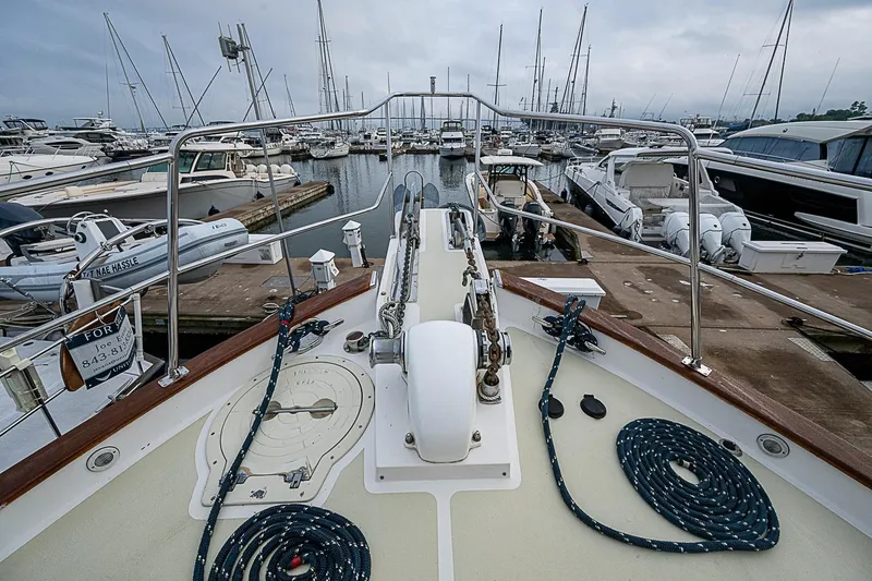 Slide: The Image of 2008 Krogen 48 North Sea yacht docked in a marina, surrounded by other boats. - 45