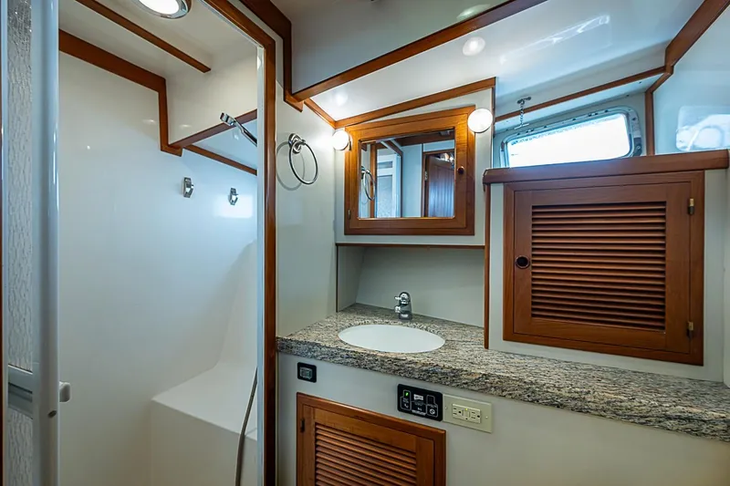 Slide: The Image of Luxurious bathroom in 2008 Krogen 48 North Sea yacht with wood accents and granite countertop. - 43