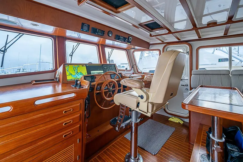 Slide: The Image of Luxurious 2008 Krogen 48 North Sea yacht interior with navigation station and plush seating. - 25