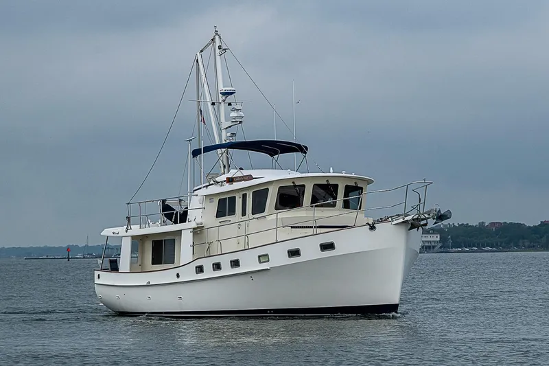 Slide: The Image of 2008 Krogen 48 North Sea yacht cruising on calm waters under a cloudy sky. - 8