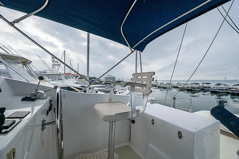 Slide: The Image of Helm of 2008 Krogen 48 North Sea yacht with marina view under cloudy sky. - 58