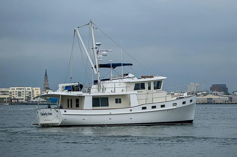 Slide: The Image of 2008 Krogen 48 North Sea yacht cruising in a harbor with cityscape background. - 13