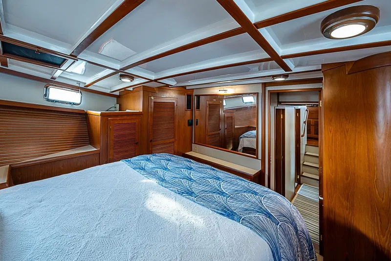 Slide: The Image of Luxurious 2008 Krogen 48 North Sea yacht bedroom with wood paneling and cozy bedding. - 29