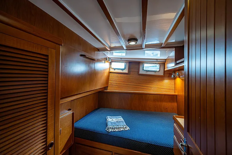 Slide: The Image of Cozy wooden cabin interior of 2008 Krogen 48 North Sea yacht with bed and portholes. - 39