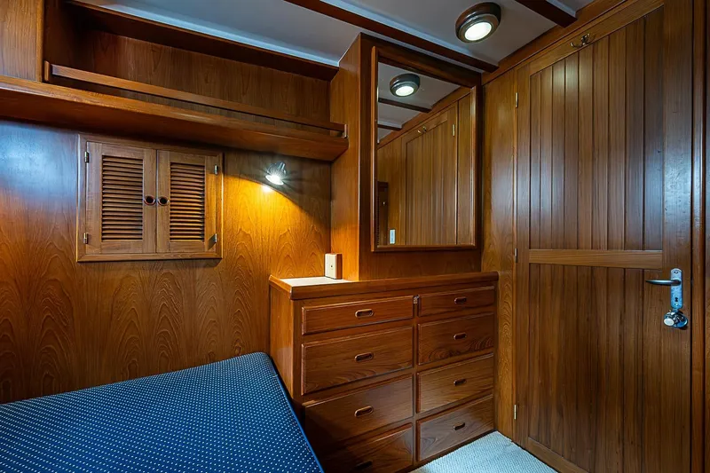 Slide: The Image of Wood-paneled cabin interior of 2008 Krogen 48 North Sea yacht with built-in storage. - 42