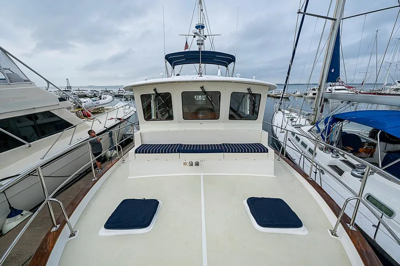 Slide: The Image of 2008 Krogen 48 North Sea yacht docked at marina, surrounded by other boats. - 46