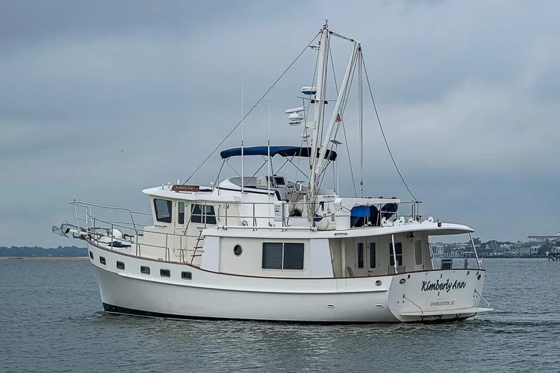 Slide: The Image of 2008 Krogen 48 North Sea yacht cruising on calm waters under cloudy skies. - 5