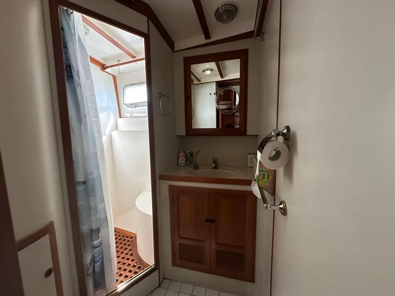 Slide: The Image of Bathroom interior of 1997 Kadey-Krogen 48 Whaleback yacht with shower and wooden cabinetry. - 36