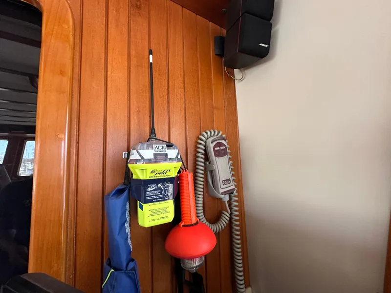 Slide: The Image of Wooden interior of 1997 Kadey-Krogen 48 Whaleback with safety equipment and communication devices. - 48