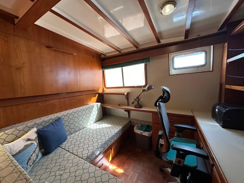 Slide: The Image of Cozy interior of 1997 Kadey-Krogen 48 Whaleback with seating, desk, and window. - 28