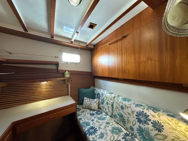 Slide: The Image of Cozy interior of 1997 Kadey-Krogen 48 Whaleback with floral sofa and wooden cabinetry. - 26