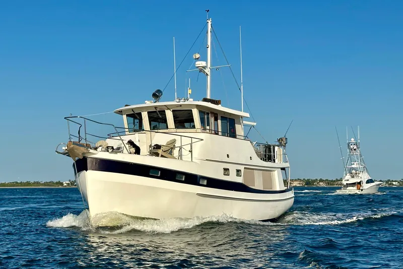 The Image of 1997 Kadey-Krogen 48 Whaleback yacht cruising on open water under clear blue sky. - 0
