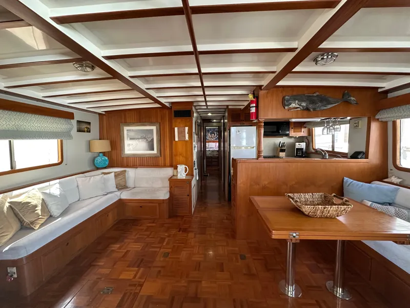 Slide: The Image of Interior of 1997 Kadey-Krogen 48 Whaleback yacht, featuring wood paneling and cozy seating. - 9