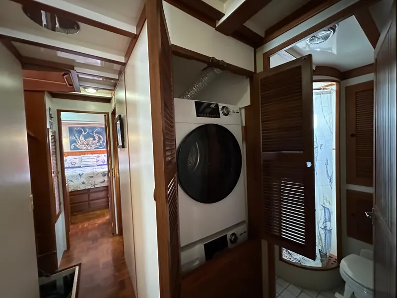 Slide: The Image of Interior of 1997 Kadey-Krogen 48 Whaleback yacht with washer, shower, and wooden accents. - 32