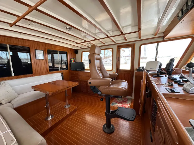 Slide: The Image of Interior of 1997 Kadey-Krogen 48 Whaleback yacht with wood paneling and captain's chair. - 40
