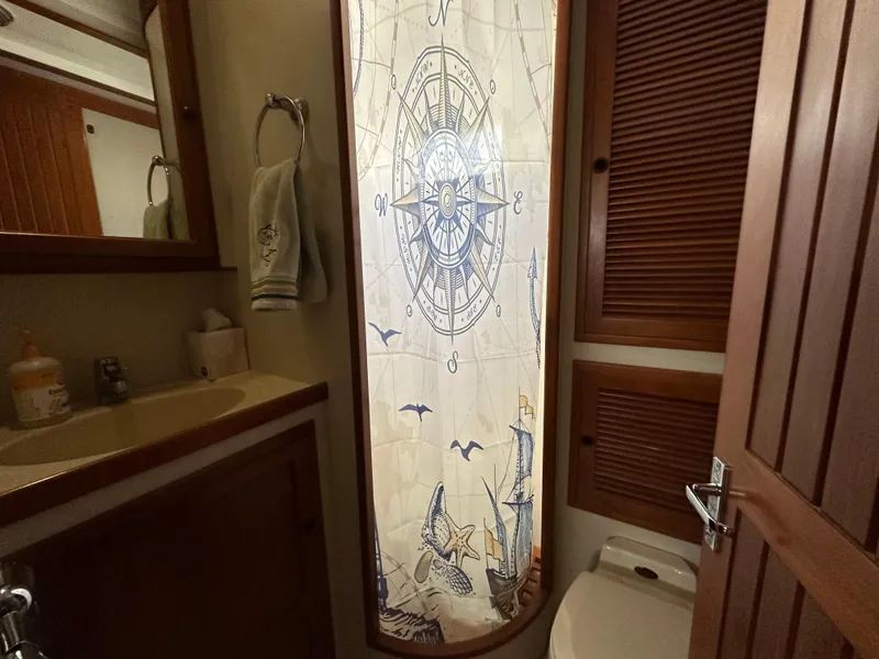 Slide: The Image of Bathroom in 1997 Kadey-Krogen 48 Whaleback with nautical-themed shower curtain. - 33