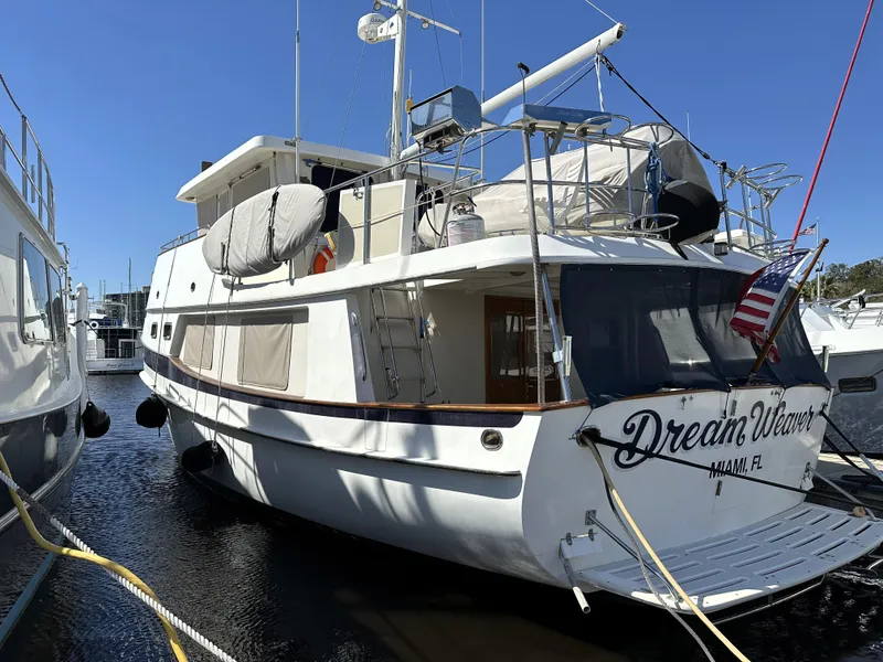 Slide: The Image of Kadey-Krogen 48 Whaleback yacht, 1997 model, docked with "Dream Weaver" name, American flag displayed. - 6