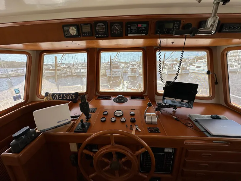 Slide: The Image of 1997 Kadey-Krogen 48 Whaleback helm with wooden wheel and navigation instruments. - 38