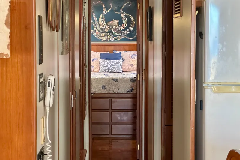 Slide: The Image of Narrow hallway in a 1997 Kadey-Krogen 48 Whaleback yacht, leading to a cozy bedroom. - 18