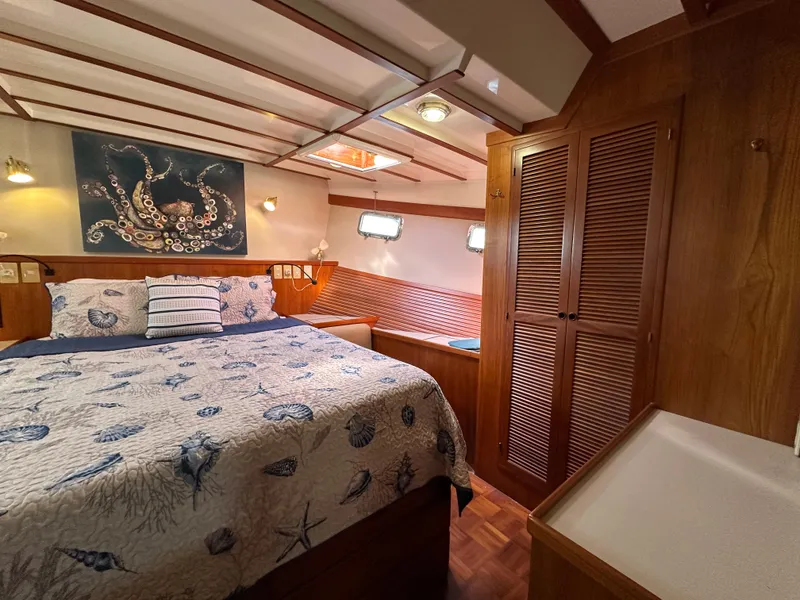 Slide: The Image of Cozy bedroom in 1997 Kadey-Krogen 48 Whaleback yacht with nautical decor and wood paneling. - 20