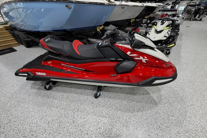 The Image of 2026 Yamaha WaveRunner VX Cruiser in showroom, red and black design, side view. - 1