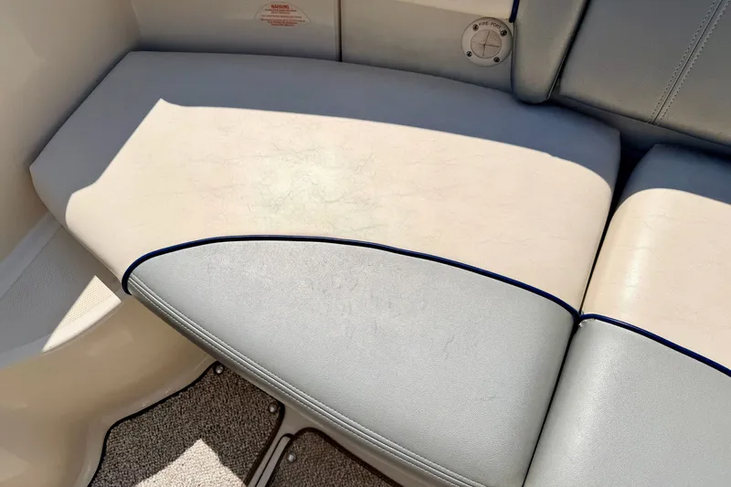 Slide: The Image of 2008 Sea Ray 195 Sport boat seat with light upholstery and blue trim. - 33