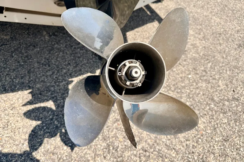 Slide: The Image of Close-up of a 2008 Sea Ray 195 Sport boat propeller on asphalt surface. - 18