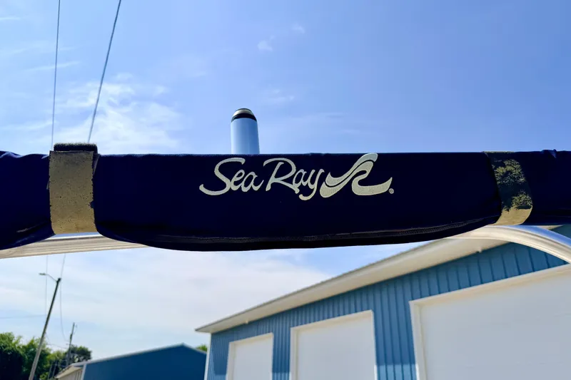 Slide: The Image of 2008 Sea Ray 195 Sport boat cover with logo against blue sky background. - 65